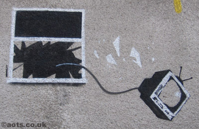 Banksy graffiti television thrown out of closed window.