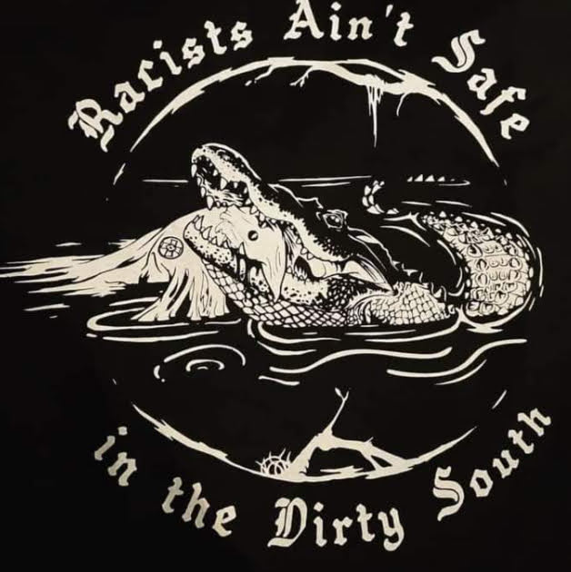 Graphic with aligator eating klansmen, text content - Racists ain't safe in the Dirty South.